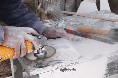 Midsection of man working at workshop