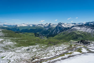 Scenic view of mountains against blue sky