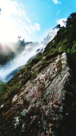 Scenic view of waterfall against sky