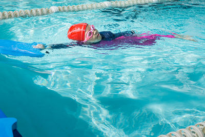 High angle view of child swimming in pool