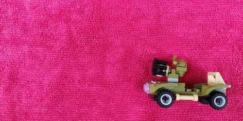 High angle view of toys on pink toy car