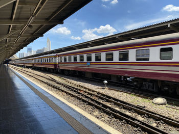 Train at railroad station against sky