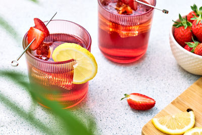 Fresh summer strawberry cocktail or mocktail on table in the garden.sparkling strawberry lemonade