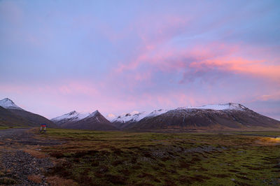 Scenic view of snowcapped mountains against sky during sunset