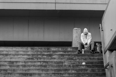 Anonymous man looking lonely or forlorn on a city staircase