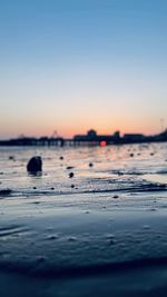 Scenic view of sea against clear sky during sunset