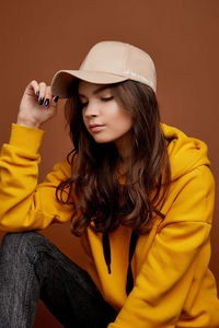 Beautiful young woman sitting in hat