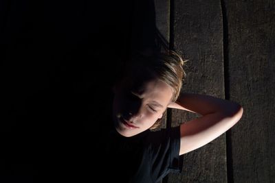 Portrait of kid lying on wooden terrace