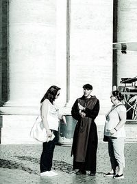 Side view of two women standing on street