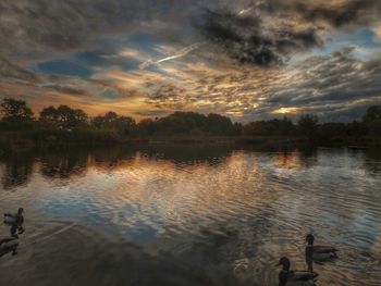 Scenic view of calm lake against cloudy sky