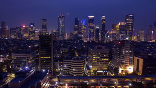 Aerial view of illuminated buildings in city at night