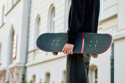 Cropped hand of woman standing outdoors