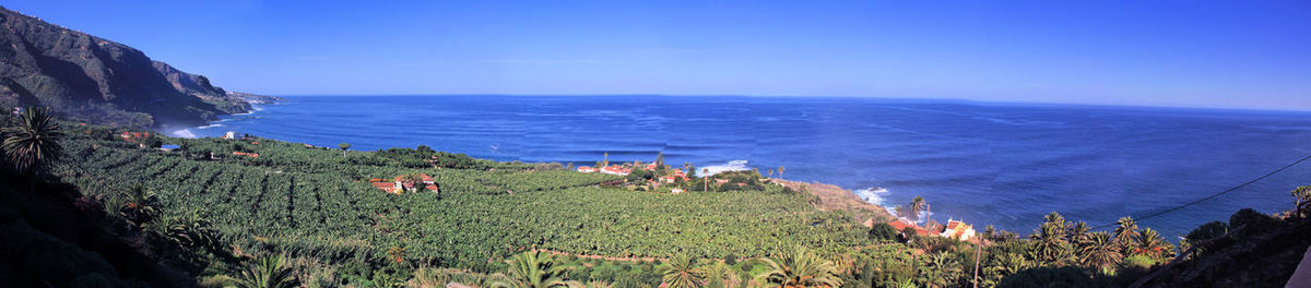 High angle view of sea against clear blue sky