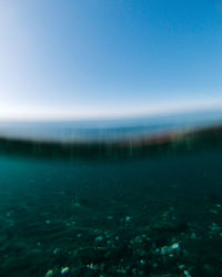Scenic view of sea against clear blue sky
