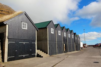 Buildings in city against cloudy sky