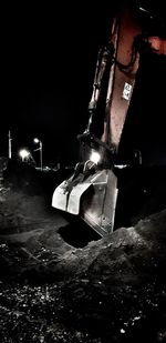 Low angle view of illuminated machine at night