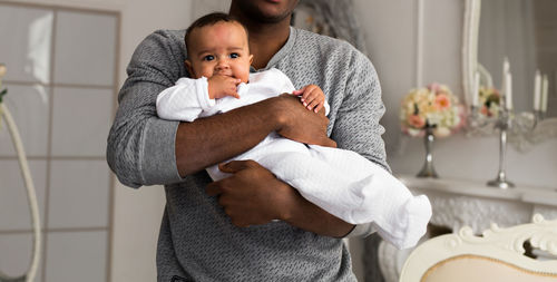 Portrait of mother with baby at home