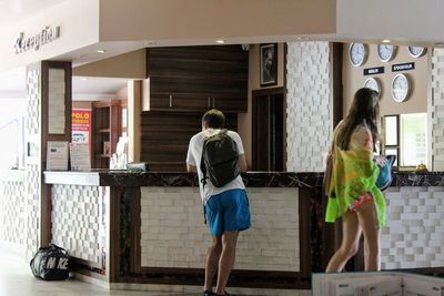 Rear view of man standing in corridor