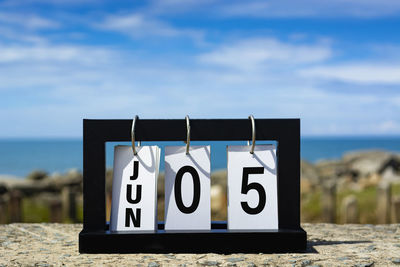 Jun 05 calendar date text on wooden frame with blurred background of ocean. calendar date concept.