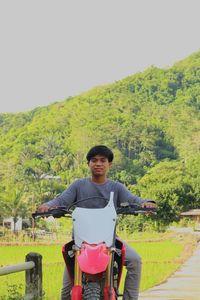 Portrait of man riding bicycle on mountain