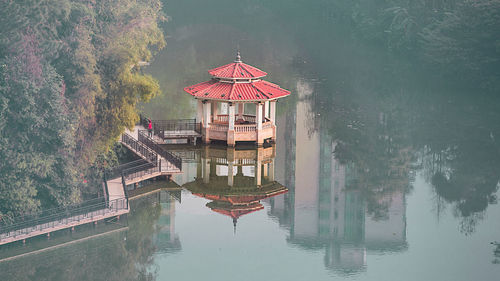 Gazebo by lake against building