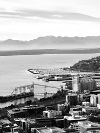 High angle view of buildings by sea against sky