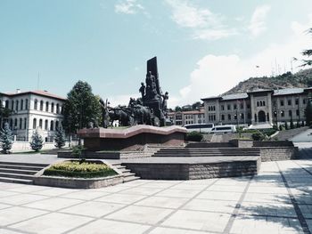 Statue of buildings against cloudy sky