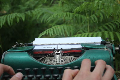 Close-up of hand writing on a typewriter