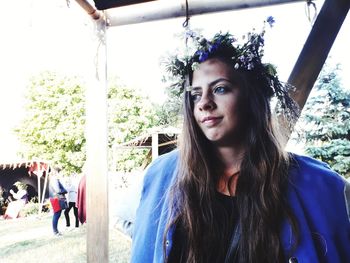 Portrait of beautiful woman against trees