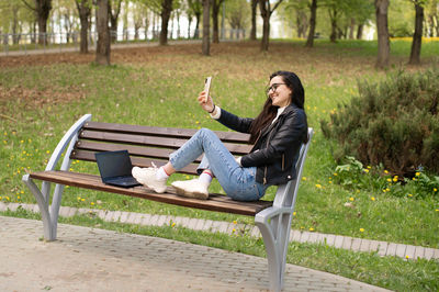 Young woman sitting on field