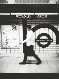 Low section of woman walking on subway station