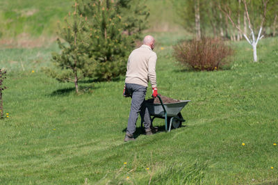 Rear view of man standing on field