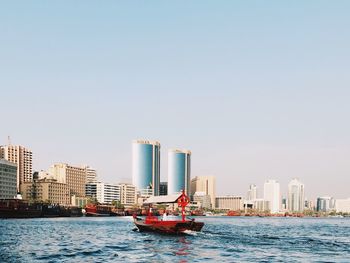 Boats in sea against clear sky