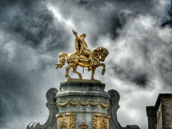 Low angle view of statue against cloudy sky