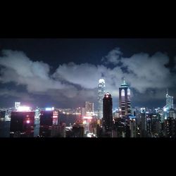 Illuminated cityscape against sky at night
