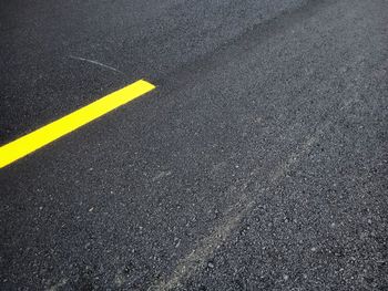 High angle view of yellow marking on road