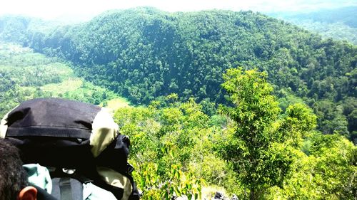 Tourist on mountain against sky