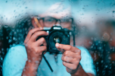 Close-up portrait of man holding glass