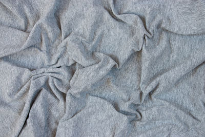 Gray fabric texture. background with folds. close-up.
