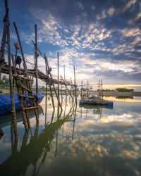 Fishing boats in marina at sunset