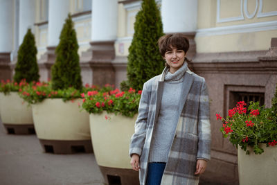 Young woman posing outdoors in coat