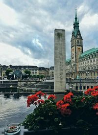 Buildings against cloudy sky