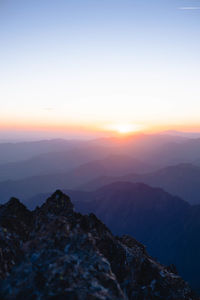 Scenic view of mountains against sky during sunset