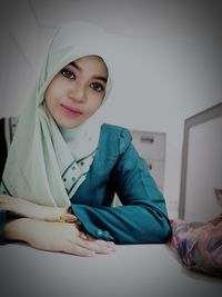 Portrait of a smiling young woman at home