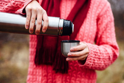 Close-up of woman holding red wine