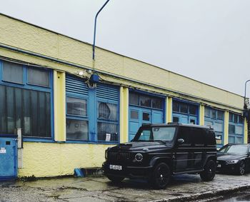 Car parked on street against buildings in city