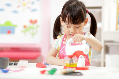 Portrait of a girl looking at table