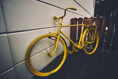 Bicycle parked by wall