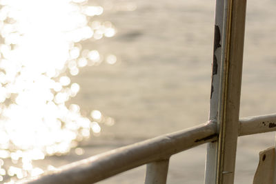 Close-up of railing by sea