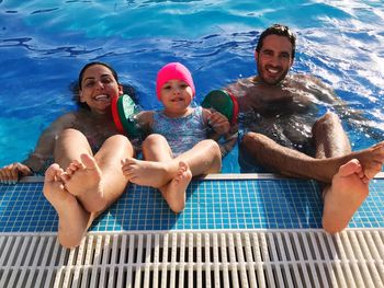 High angle portrait of happy family in swimming pool